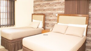 A hotel room with two beds, a wooden wall, and a window with blinds. - The Vista Inn Suite #5 (Falmouth)