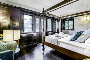 A room with a bed, a desk, and a chair.