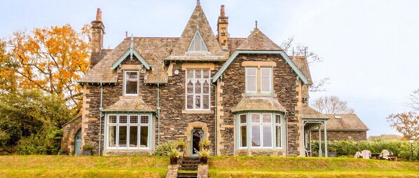 A stone house with multiple gabled roofs and a central tower. - Lakestone House - Five Bedroom Villa, Sleeps 10 (Windermere)