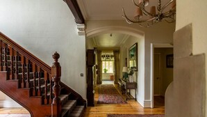 A wooden staircase with a handrail, a patterned rug on the floor, and a chandelier. - Lakestone House - Five Bedroom Villa, Sleeps 10 (Windermere)