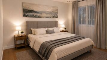 A bedroom with a bed, two bedside tables, a ceiling fan, a painting on the wall, and a window with curtains.