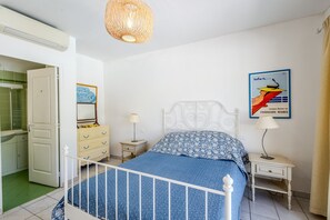 A bedroom with a bed, bedside tables, a lamp, a hanging light fixture, a mirror, and a poster on the wall. - Villa Chautard - Four Bedroom Villa, Sleeps 8 (Tourrettes)