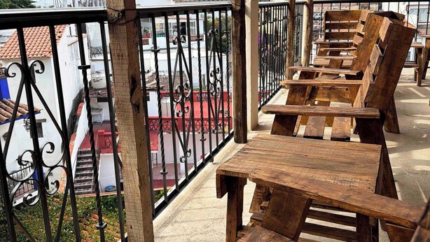 A wooden deck with benches overlooking a residential area. - La Casona de Los Angeles de San Juan (Taxco)