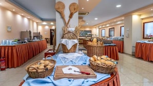 Montaje de bufé con cestas de pan, una tabla de cortar y un cartel que indica 'Letter only'.