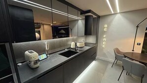 A modern kitchen with a built-in oven, a coffee machine, and a sink. - Luxury Penthouse with Private Heated Pool & Christ the Redeemer Views in Ipanema (Rio de Janeiro)