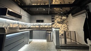 A modern kitchen with a built-in oven, microwave, and stainless steel appliances. - Luxury Penthouse with Private Heated Pool & Christ the Redeemer Views in Ipanema (Rio de Janeiro)