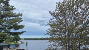 A lakeside property with a dock, outdoor seating, and a view of the water. - Northern Paradise on the lake with water activities, Pet-friendly (Hagar)