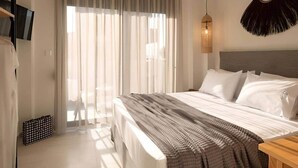 A hotel room with a large bed, a TV mounted on the wall, a ceiling light fixture, and a window with sheer curtains. - Villas Thallo № 3 (Neos Marmaras)