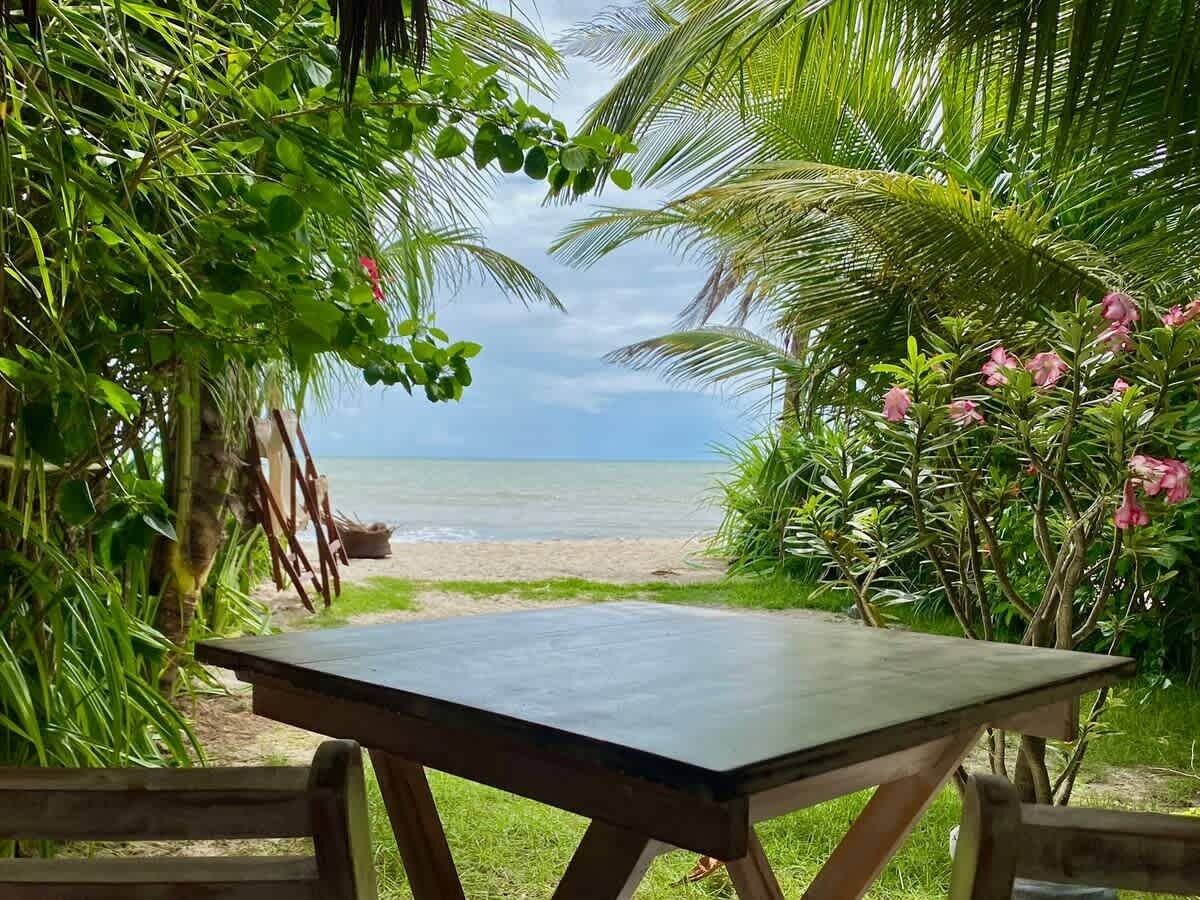 A table with a view of a beach and ocean.