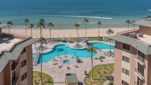 A resort with a swimming pool, beach, and palm trees. - Stunning Oceanfront Escape With Sweeping Sea Views (Puerto Peñasco)