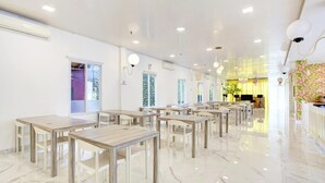 A spacious hotel lobby with marble flooring, multiple tables, and chairs arranged for seating. - Stylish Twin Suite Escape W/ Free Wifi and Parking (Jakarta)