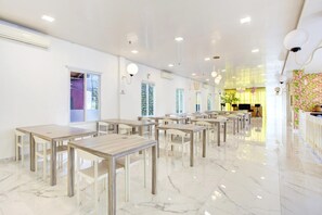 A spacious hotel lobby with marble flooring, multiple tables, and chairs arranged for seating. - Stylish Twin Suite Escape W/ Free Wifi and Parking (Jakarta)
