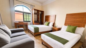A hotel room with two beds, a sofa, a desk, and a large window. - HOTEL SAN JOSE CENTRO HISTORICO (San Luis Potosí)