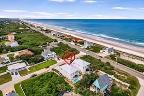 An aerial view of a coastal residential area with a beachfront, houses, and a road. - Grand Vilano Compound: 18 Guests, 2 Pools (St. Augustine)
