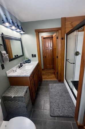 A bathroom with a sink, mirror, and shower. - Observation Deck, Breath Taking Grand Canyon Views (Jasper)