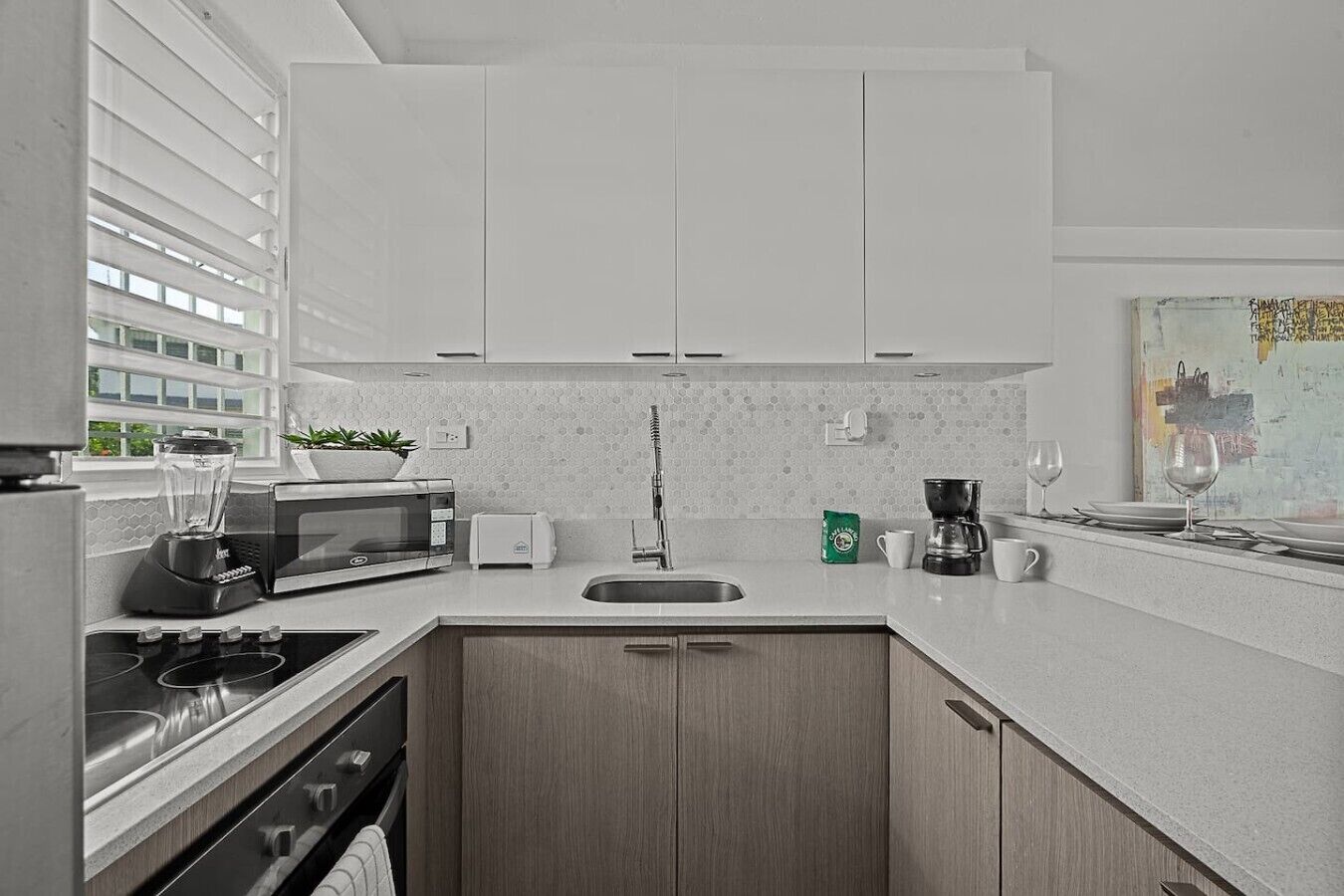 A modern kitchen with a built-in stove, microwave, and toaster.