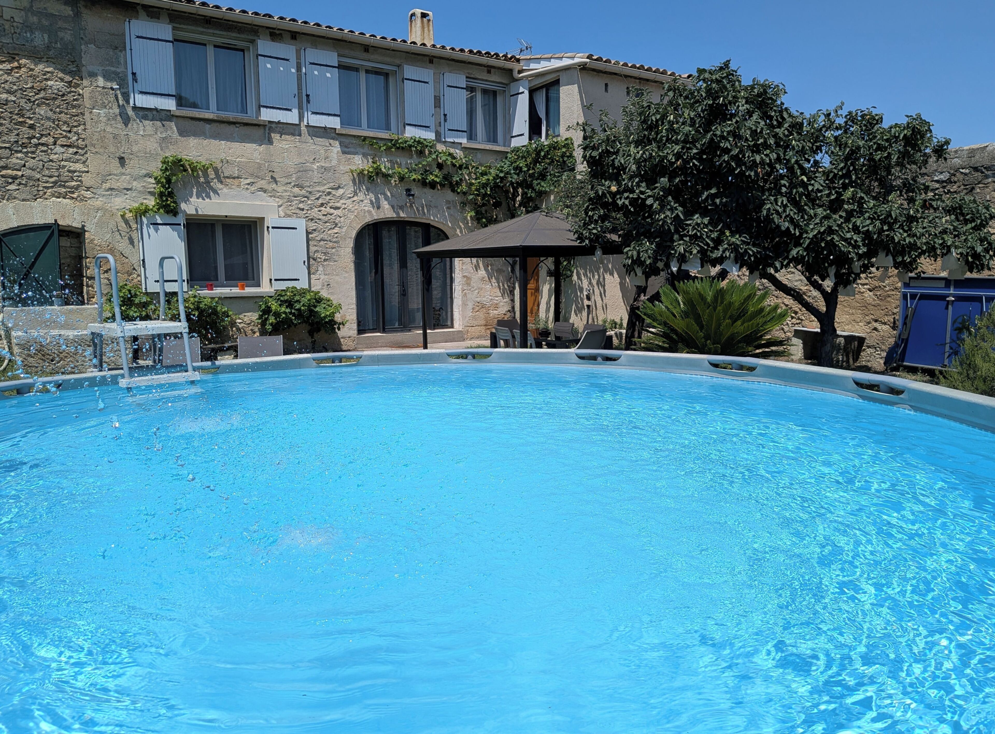 A swimming pool with a stone building in the background.