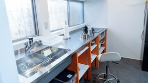 A modern kitchen with stainless steel appliances, a sink, and a window. - Korean Town Front/ Sleeps 8/ 9 Min Walk to Tsuruhashi St/ Direct Access to Namba (Osaka)