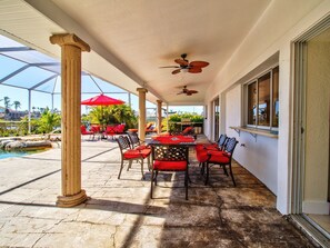 Outdoor dining - Waterpark Style Pool With Hot Tub in Grotto With Waterfall and Bridge Over Pool (Cape Coral)