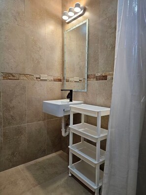 Shower, hair dryer, towels, toilet paper