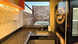 A modern kitchen with a built-in oven, a sink, and a large window. - Exclusive Loft | Rooftop with Panoramic Views (São Raimundo Nonato)