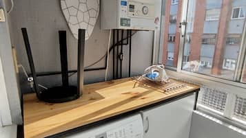 A kitchen with a wooden countertop, a black stand, and a water heater.