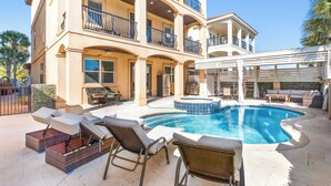 A large two-story house with a swimming pool, outdoor furniture, and a covered patio area. - Miramar Beach Home, Pool, Hot Tub & Chef's Kitchen (Miramar Beach)