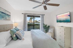 A bedroom with a bed, a dresser, a TV, a ceiling fan, and a window with curtains. - After Dune Delight Condo with Pools & Tennis (Santa Rosa Beach)