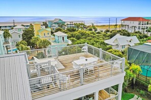 A multi-story building with a rooftop deck, pool, and ocean view. - Destin Home for Groups with Pool & Game Room (Destin)