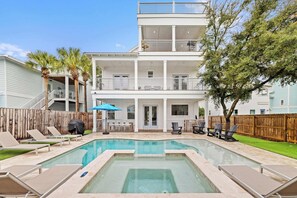A two-story house with a swimming pool, outdoor furniture, and a wooden fence. - Destin Home for Groups with Pool & Game Room (Destin)