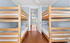 A room with bunk beds, a hallway, and a door leading to an outdoor area. - Seacrest Home with Pool & Private Beach Access (Rosemary Beach)