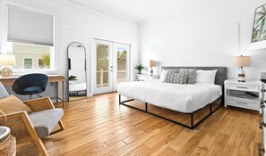 A bedroom with a bed, bedside tables, a chair, a desk, and a large mirror. - Santa Rosa Home with Pool, Deck & Beach Access (Santa Rosa Beach)