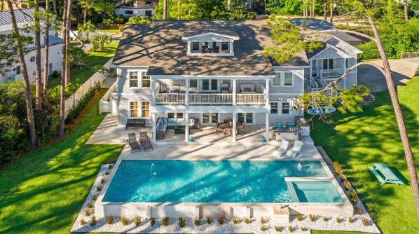 A large two-story house with a swimming pool, outdoor seating, and a well-maintained lawn. - Oyster Lake Estate with Pool, Dock & Golf Cart (Santa Rosa Beach)