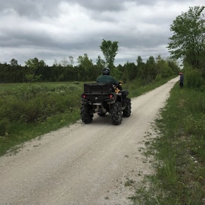 A dirt road with a vehicle and a person standing on the side. - key motel (Chatsworth)