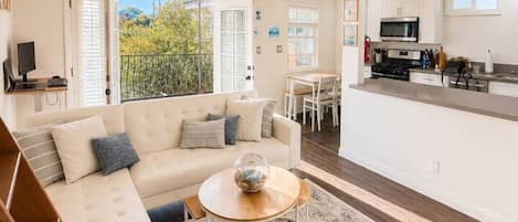 A modern living room with a sofa, coffee table, and a ceiling fan.