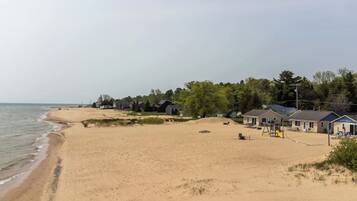 A beach with houses, a playground, and a clear sky.