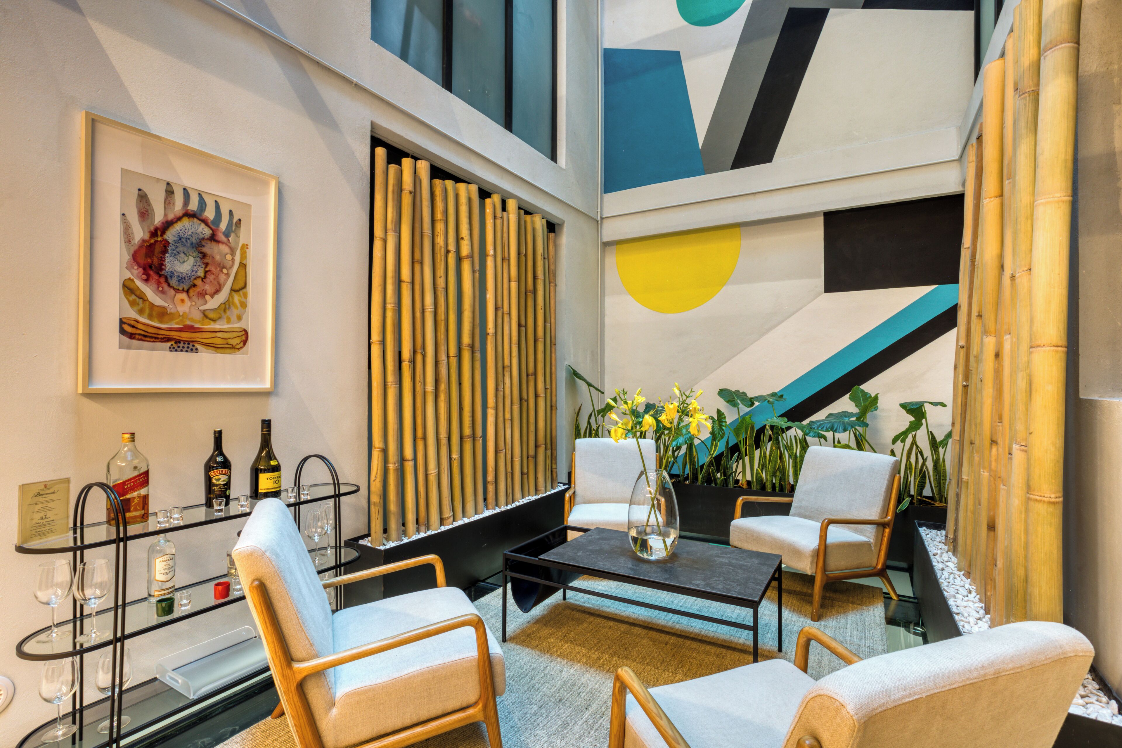 A modern interior with a seating area, a bar, and a decorative wall.