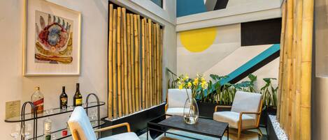 A modern interior with a seating area, a bar, and a decorative wall.
