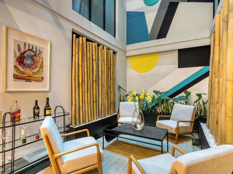 A modern interior with a seating area, a bar, and a decorative wall.
