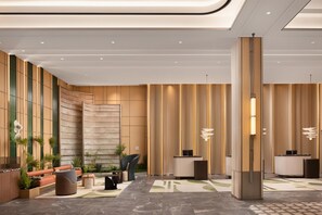 A modern lobby with a reception desk, seating area, and decorative lighting. - Hilton Garden Inn Chengdu Jinnan Tianjie (Chengdu)