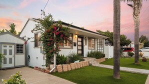 A single-story house with a front porch, a small attached garage, and a well-maintained lawn. - Golden Hour Overlook | Spa | In-Law Suite | Grill (San Diego)