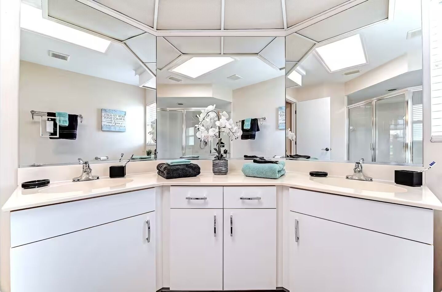 Spacious master bathroom featuring modern twin sinks and large vanity mirrors.