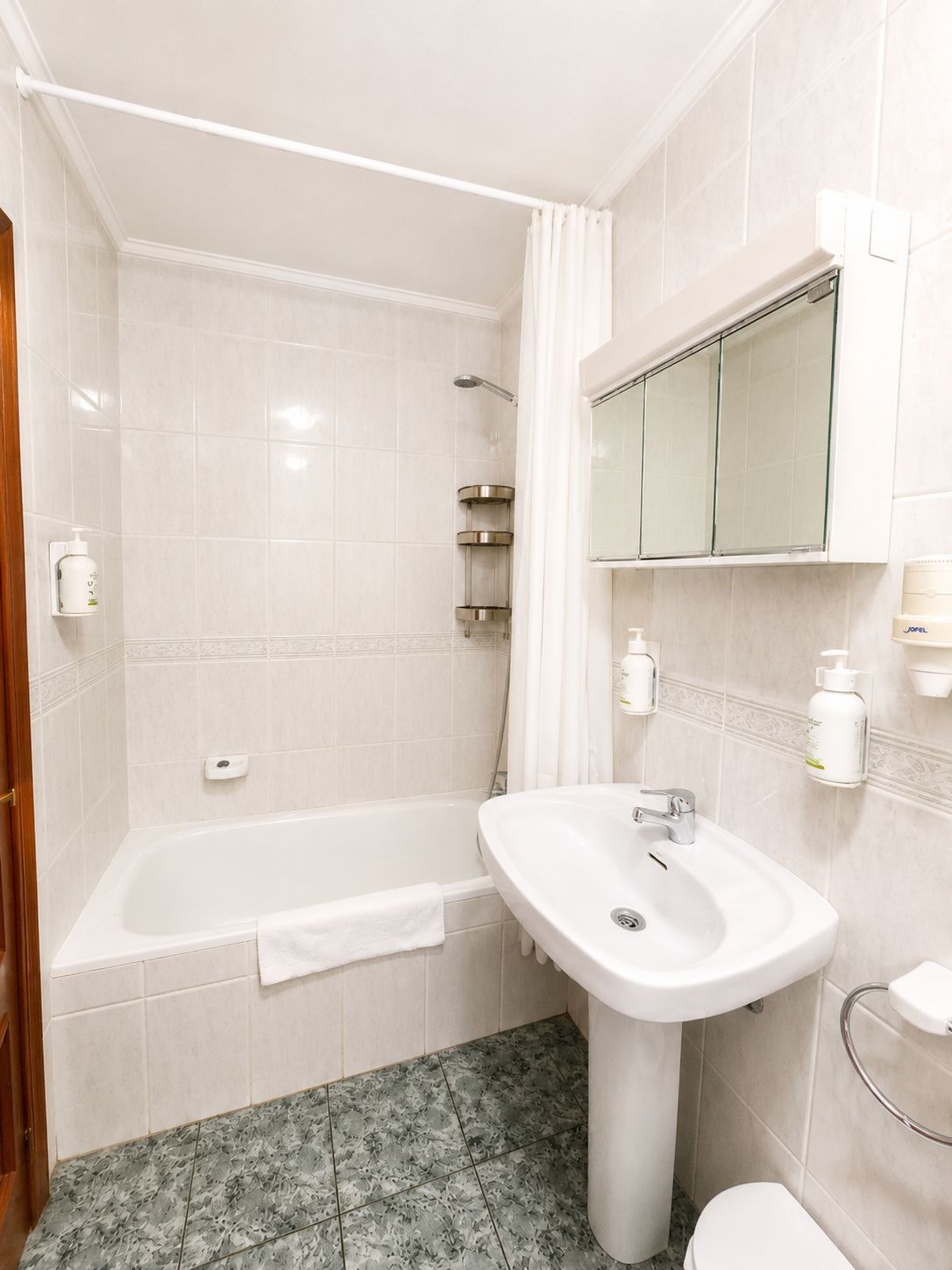 A bathroom with a bathtub, a sink, and a toilet.