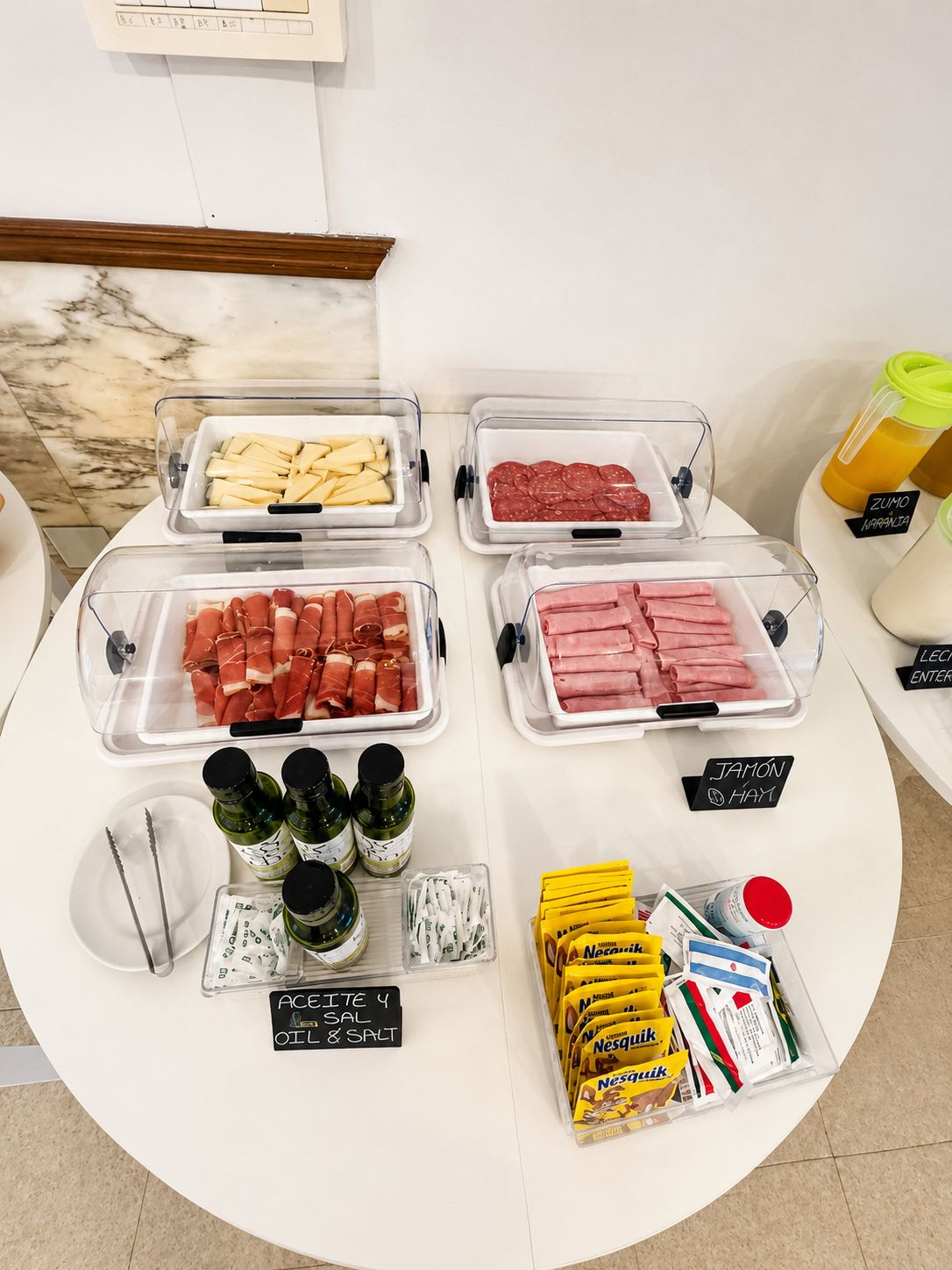 A food display with various meat options and condiments.