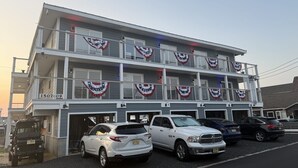 A multi-story building with a parking area. - Relaxing Coastal Retreat in Cape May! Condo #8 (Cape May)