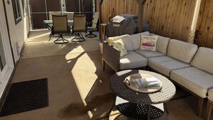 An outdoor patio with a covered seating area, a grill, and a dining table. - Charming 2 BR Little Oasis, with  pool, near Colorado River, SNOWBIRD FRIENLDY (Bullhead City)