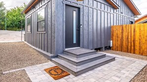 A modern house with a grey exterior, a dark front door, and a wooden fence. - Old Town Cottonwood-Walk to Shops & Dining (Cottonwood)