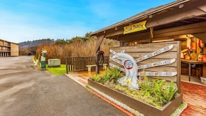 A wooden building with a sign reading 'CLAM SHACK' and a display of skis.