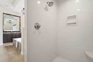 A modern bathroom with a shower, a sink, and a vanity.