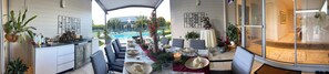 Comedor con vista a la piscina, mobiliario exterior y zona de cocina.